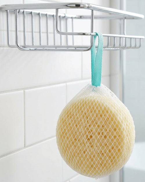 Haud Net-Covered Cellulose Sponge Bath Ball 11 cm Pale Yellow - Lifestyle view